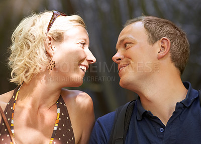 Buy stock photo Smile, love and couple together outdoor, healthy relationship and connection in nature. Happy man, woman and romantic people looking at each other, bonding and support, trust and face profile on date