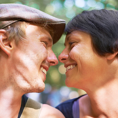 Buy stock photo Smile, love and face profile of couple together outdoor, healthy relationship and connection in nature. Happy man, woman and romantic people looking at each other, bonding and support, kiss and date