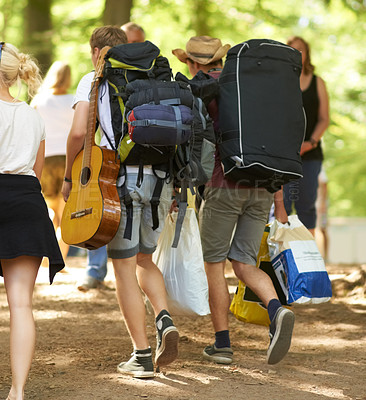Buy stock photo Outdoor, concert and people with backpack, walking and friends with freedom, party and festival. Men, women and group with social event, celebration and guitar with reunion, bonding together and joy