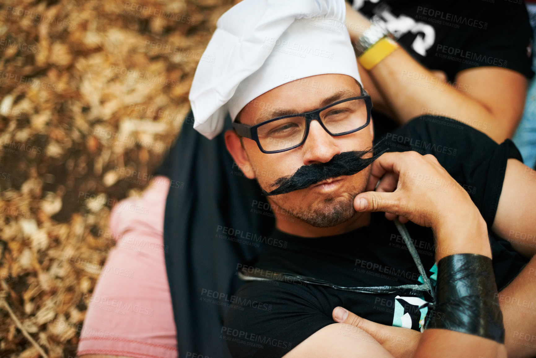 Buy stock photo Face, thinking and a man in a chef costume outdoor at a music festival for celebration or performance. Idea, relax or funny and a young person at a carnival for an event or show with his friends