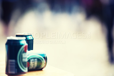 Buy stock photo Space, blurred background and cans of beer closeup outdoor at a music festival for drinking or celebration. Party, product and alcohol with lager or ale at a carnival for the enjoyment of a beverage
