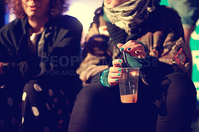 Buy stock photo Hands, drink and friends outdoor at a music festival together for an event, show or performance. Cup, cocktail and alcohol with a person at a night carnival for celebration or entertainment closeup