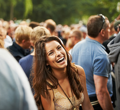 Buy stock photo Portrait of an attractive woman laughing in a crowd at a music festival