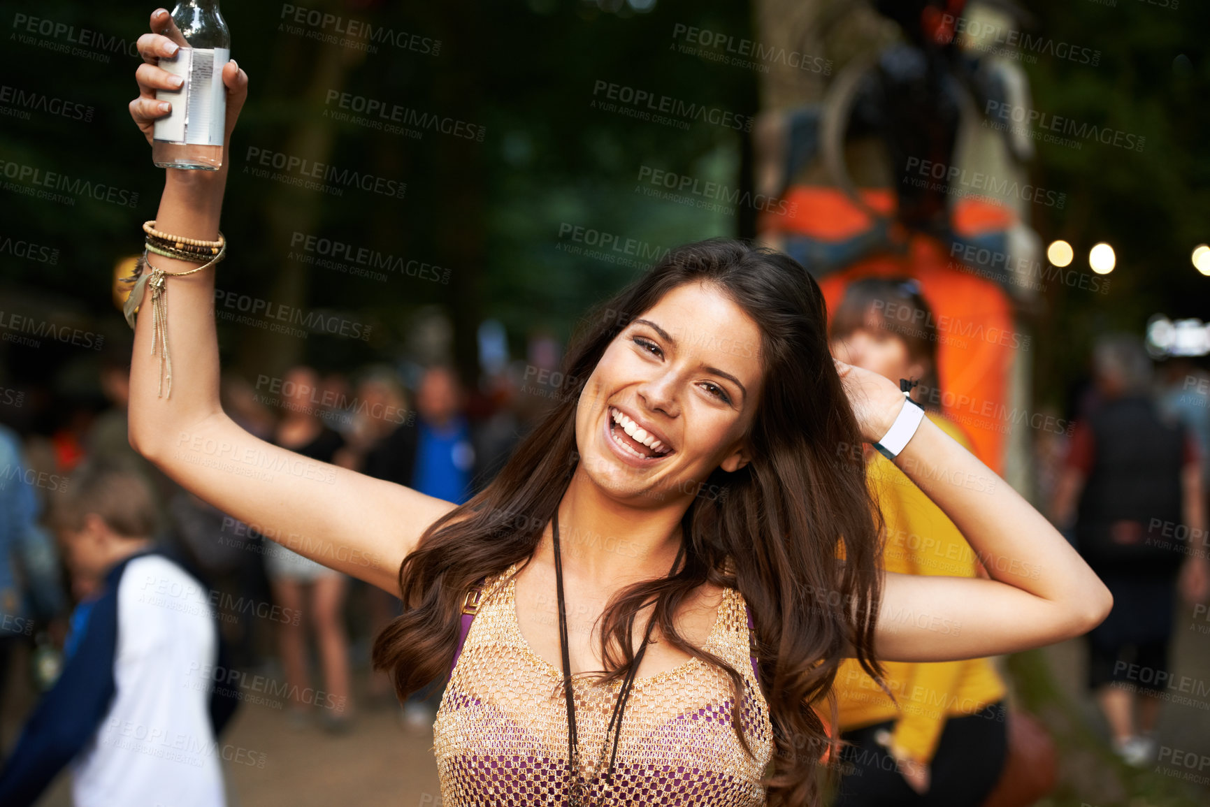 Buy stock photo Outdoor music festival, night portrait and happy woman having fun, happiness and smile at event. Dark rave concert, alcohol drinks and person spring break vacation, entertainment or social gathering
