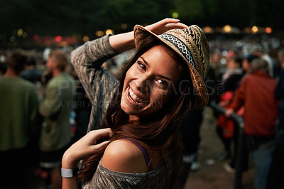 Buy stock photo Happy woman, portrait and night at music festival party, event or outdoor DJ concert. Face of female person smile with hat in evening crowd or audience at carnival, performance or summer fest outside