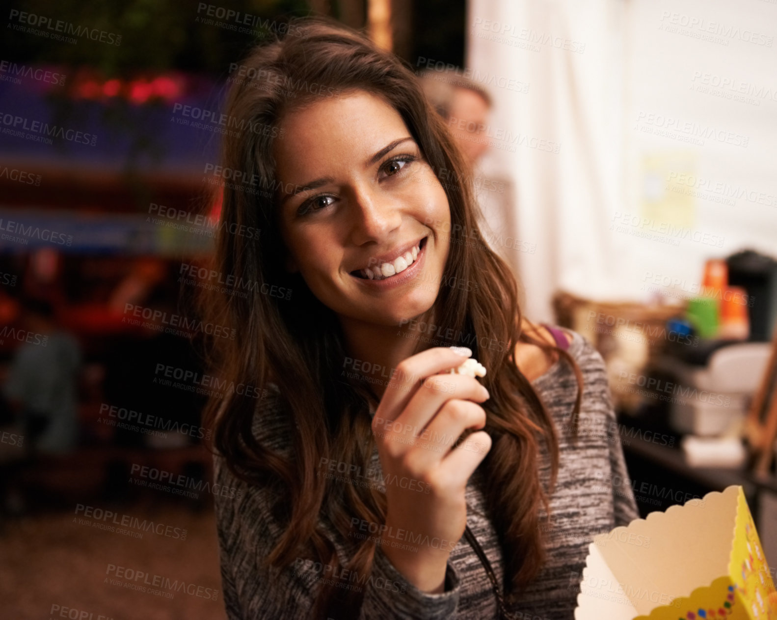 Buy stock photo Portrait, smile and popcorn with a woman at a music festival for a concert, show or live performance. Party, food and summer with a happy young person eating a snack outdoor at a carnival event