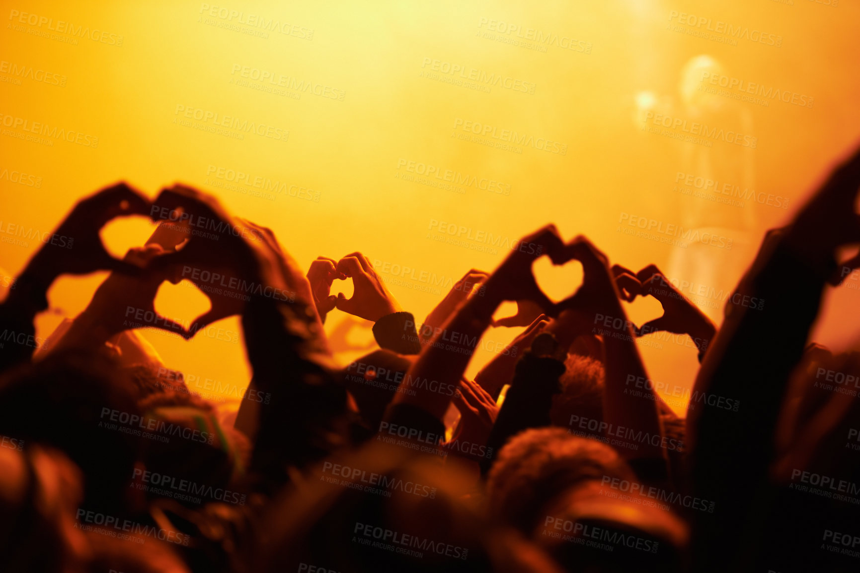 Buy stock photo Rear view of an audience making heart-shapes with their hands