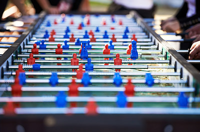 Buy stock photo Foosball table, competitive and leisure with people playing a game outdoor at a music festival together. Party, event or social gathering with friends at a carnival for tabletop soccer or football