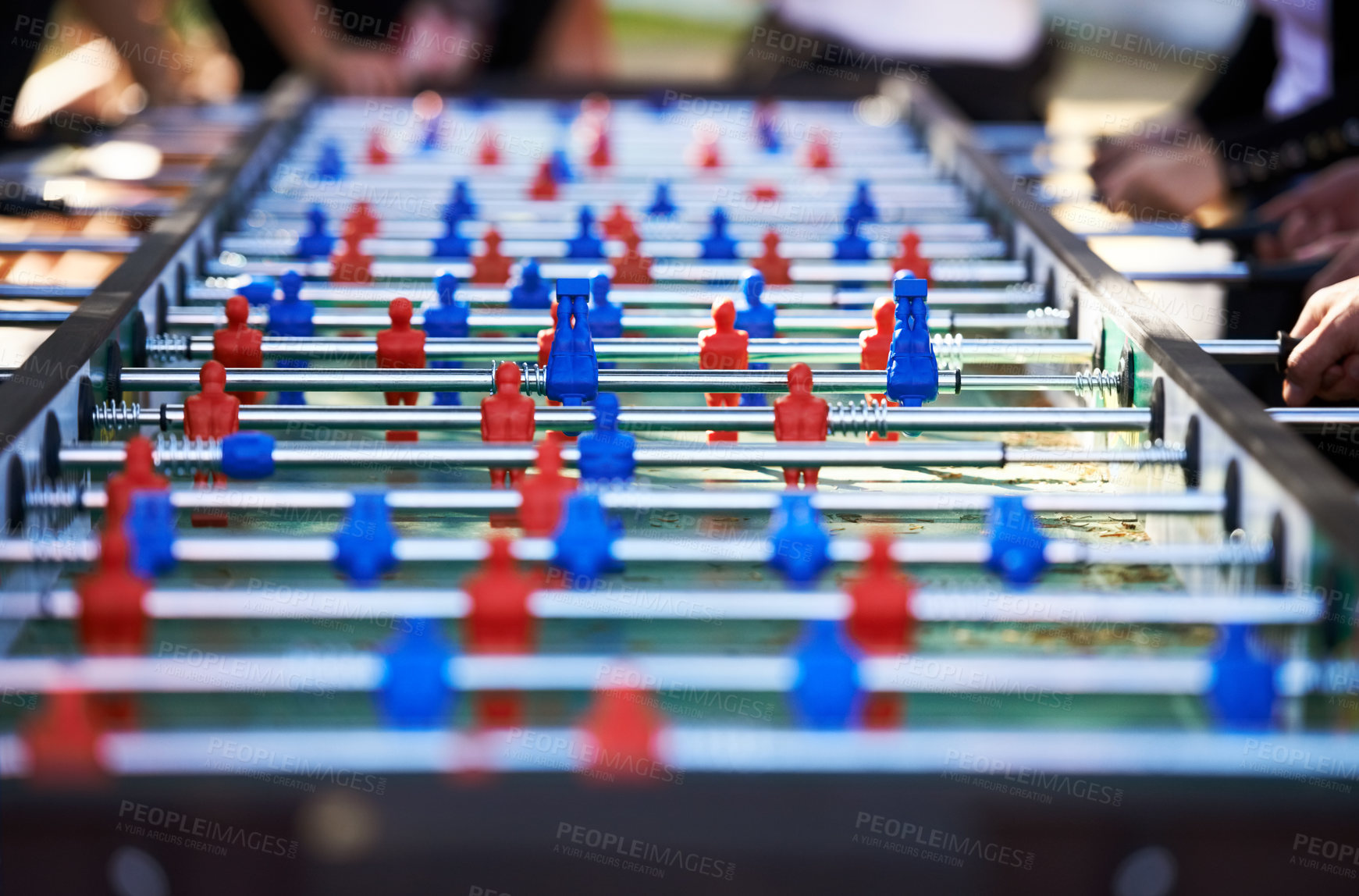 Buy stock photo Foosball table, competitive and leisure with people playing a game outdoor at a music festival together. Party, event or social gathering with friends at a carnival for tabletop soccer or football