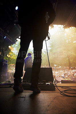 Buy stock photo Musician, music festival and back on stage in outdoors, guitarist and event or energy for freedom at party. Person, concert or rave or performer, audio and playing or entertainment for audience
