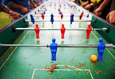 Buy stock photo Playing, foosball and people outdoor with table, game or closeup on competition with ping pong ball. Soccer, board and small plastic football players or toys for social, event or sport at pub for fun