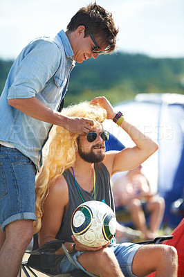 Buy stock photo Men, friends and music festival or fun camping outdoor concert for summer event, entertainment park or games. Male people, wig and laughing for funny at tent on nature field, party or celebration