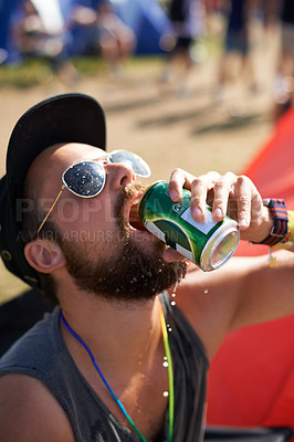 Buy stock photo Man, drinking and beer in outdoors, music festival and alcohol and relaxing at party or camp. Male person, fun and crazy in nature, outside and freedom or energy for celebration at social event