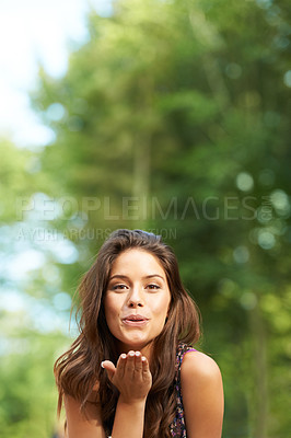 Buy stock photo Blowing kiss, nature and portrait of woman in park for holiday, summer vacation and adventure. Happy, smile and face of person outdoors with flirting emoji, love hand gesture and relax in woods