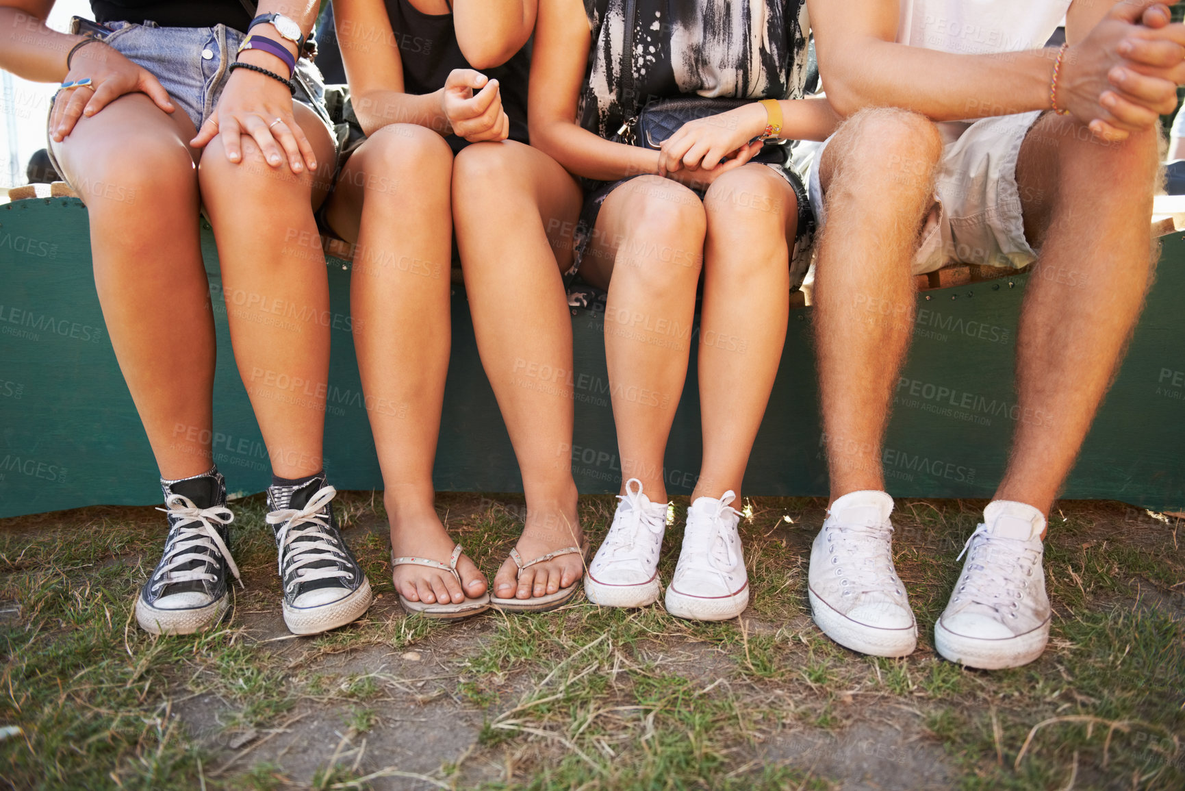 Buy stock photo Legs, feet and friends outdoor at a music festival together for social gathering at a concert or event. Shoes, sneakers or footwear with a group of people sitting in a nature park for entertainment