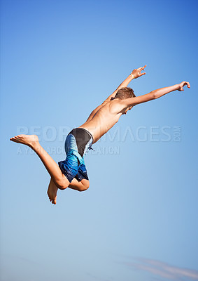 Buy stock photo Jumping, blue sky and man with energy, outdoor and excited with nature, environment and water. Person, outside and guy with vacation, mockup space and lake with summer, weekend break and excitement
