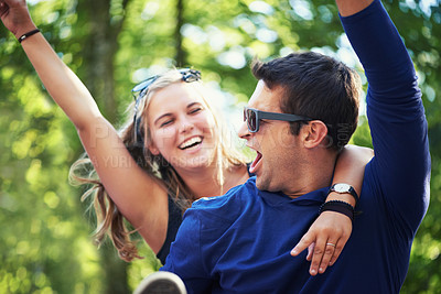 Buy stock photo Piggyback, dance or happy couple in nature on holiday vacation to relax with smile in park together. New year, man screaming or excited woman with freedom, connection or energy for fun celebration
