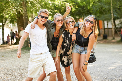 Buy stock photo Hug, celebration and friends at a park for festival, concert or happy social gathering. Face, fun and people in a forest with freedom, energy and excited for event, reunion or party with rocker hands