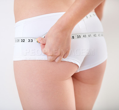 Buy stock photo Hands, underwear and woman with tape measure on butt  for weight loss, body health and wellness isolated on a white studio background. Beauty, girl and closeup of back for diet, care or slim figure