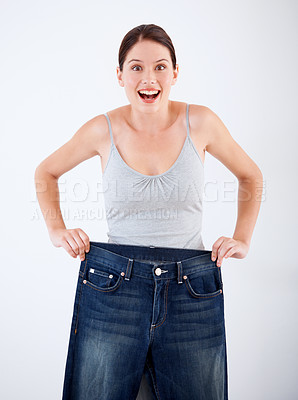 Buy stock photo Woman, lose weight and portrait of surprise with jeans, change in size or white background in studio. Wow, shocked and person with crazy transformation in fitness, health or comparison in denim pants