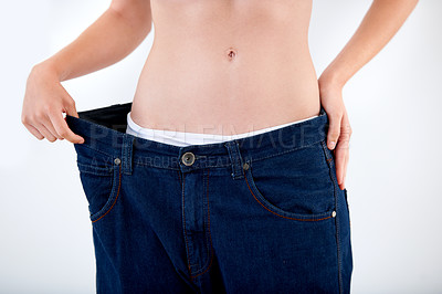 Buy stock photo Weight, loss and abdomen of woman in jeans with comparison of size on white background in studio. Healthy, body and person with transformation or change from diet and show results in denim pants