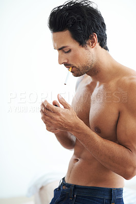 Buy stock photo Handsome man, cigarette and smoking for addiction, drag or tobacco against a white studio background. Face of young and attractive male person, model or smoker addict relax shirtless in stress relief
