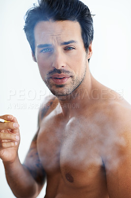 Buy stock photo Handsome man, portrait and smoking cigarette in addiction, drag or tobacco against a white studio background. Face of attractive male person, model or shirtless addict smoker in stress relief smoke