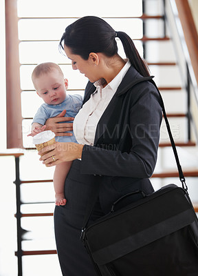 Buy stock photo Working mother standing with her briefcase holding a baby