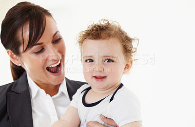 Buy stock photo Happy, baby and mom in portrait with business, work and motherhood with a professional career. Mockup, space and woman in a suit smile with love, care and playing with child in home or morning
