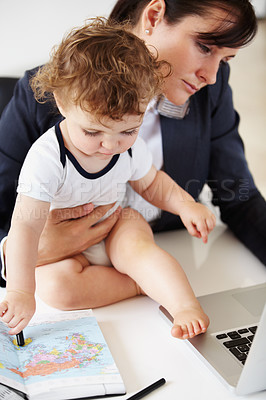Buy stock photo Working mother holding a baby while talking on the phone