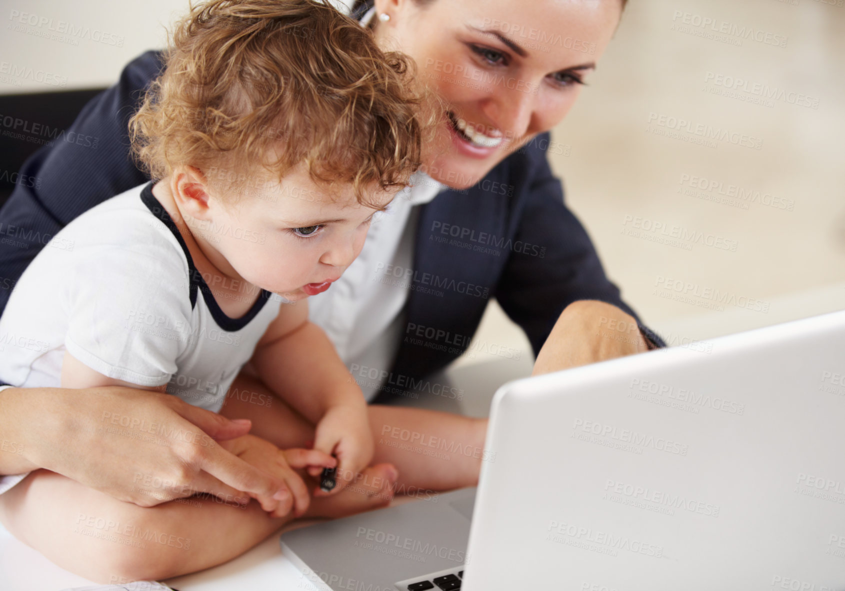 Buy stock photo Working, mom and happy with baby on laptop for business, work or multitask motherhood and career. Busy, mother and woman in a suit smile with love, care and reading on computer with child in home