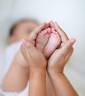 Buy stock photo Cropped shot of a mother holding her baby