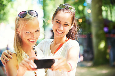 Buy stock photo Young woman taking a photo with a smartphone of themselves