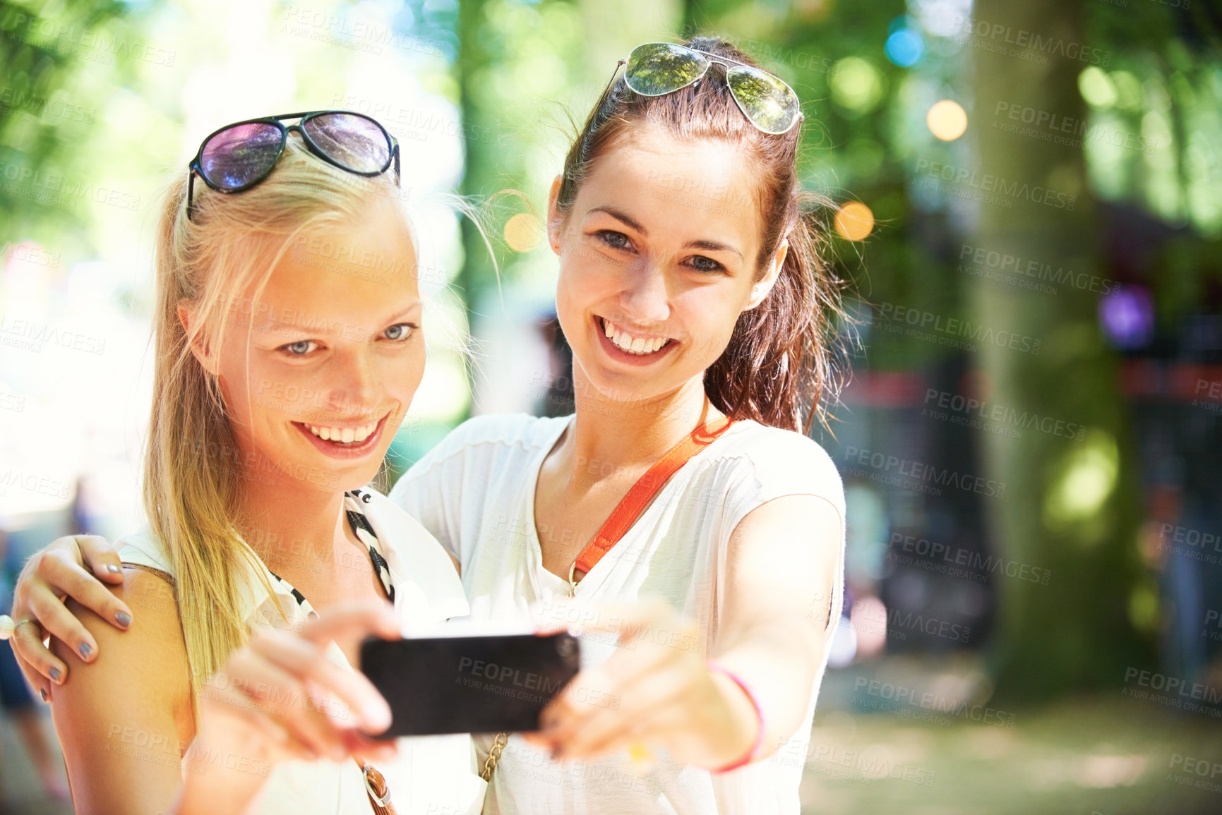 Buy stock photo Young woman taking a photo with a smartphone of themselves