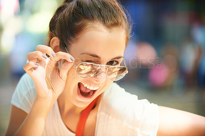 Buy stock photo Woman, portrait and sunglasses for outdoor wink fun at summer festival in nature for camping, social gathering or explore holiday. Female person, face and eyewear for sunny, travel or happy adventure