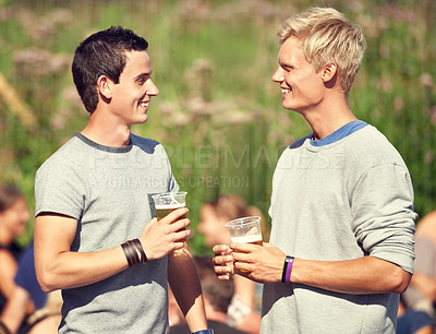 Buy stock photo Men, talking and drinks in summer with beer, alcohol and happiness at outdoor, music festival or event. Happy, conversation and friends in park for concert, celebration and drinking together in woods