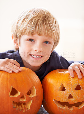 Buy stock photo Boy, portrait and happy with pumpkin for halloween, celebration or decoration in kitchen of apartment or home. Kid, face and smile with vegetable for preparation, holiday or creative event in house