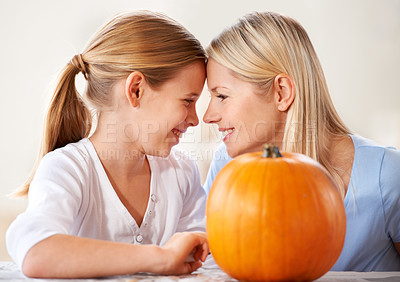 Buy stock photo Mother, daughter or happy and pumpkin for halloween, celebration or decoration in kitchen of apartment or home. Family, face or smile and vegetable for preparation, holiday or creative event in house
