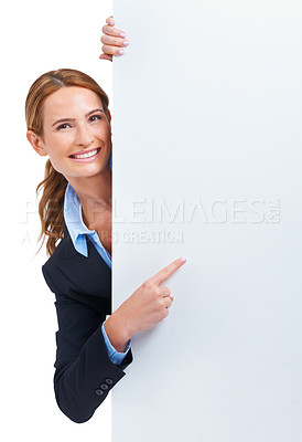 Buy stock photo A young businesswoman pointing at copyspace