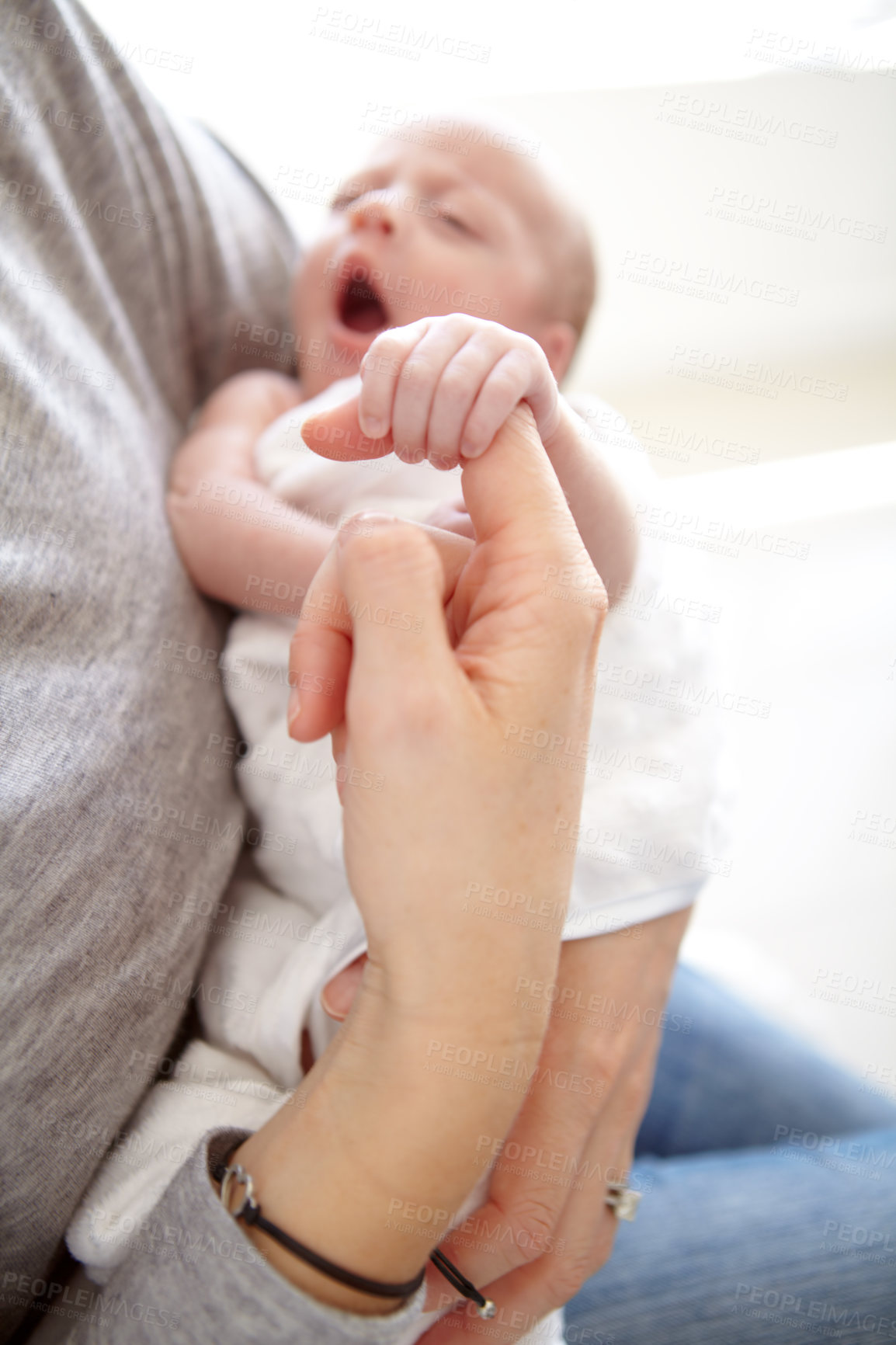 Buy stock photo Shot of a newborn girl being held by her mother