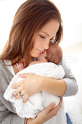 Buy stock photo Shot of a young mother holding her newborn baby girl in her arms