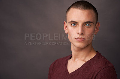 Buy stock photo Studio shot of a handsome young man looking at the camera