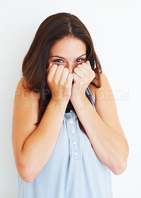 Buy stock photo Excited, hiding and portrait of shy woman with playful energy in white background of studio. Happy, emoji and person with hands to cover face for gossip story, information or reaction to drama