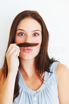 Buy stock photo Comic, portrait and a woman with hair moustache isolated on a white background in studio. Smile, funny and a young girl being crazy, making face and playing with hairstyle for comedy on a backdrop