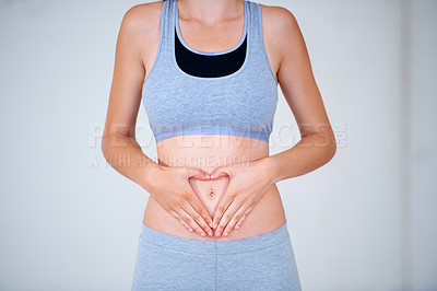 Buy stock photo Heart, hands on stomach and woman for fitness, workout and exercise to lose weight. Happy, gut health and person with emoji, symbol or shape on tummy for wellness, digestion and diet for healthy body