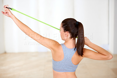 Buy stock photo A beautiful young woman doing resistance training in the gym