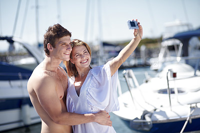 Buy stock photo Camera, selfie and couple hug, smile and pose at harbor for travel, honeymoon or trip together. Love, picture and traveling influencer people embrace for photo before cruise ship, vacation or holiday