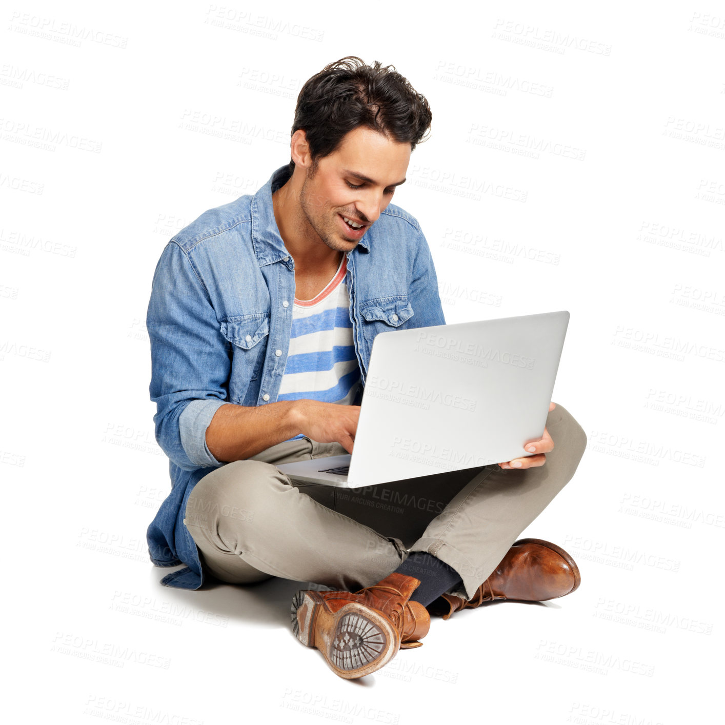 Buy stock photo A handsome young man working on his laptop against a white background