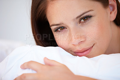 Buy stock photo Portrait, cushion and bedroom with woman, relax and resting with weekend break, lazy and wellness. Face, person and apartment with girl, pillow and peace with freedom, home and blanket with health
