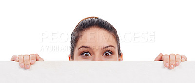 Buy stock photo Studio shot of a young women peering over a bank placard isolated on white